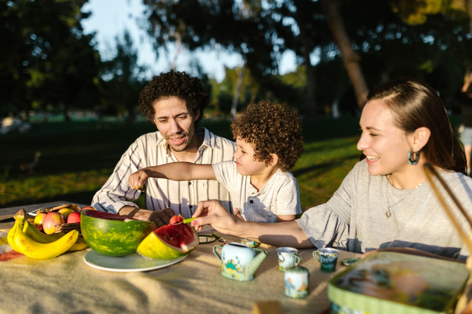 A family sharing fresh fruit and healthy snacks outdoors